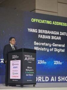 Datuk Fabian Bigar, Secretary-General of Malaysia's Ministry of Digital, speaking at the podium during his officiating address at World AI Show Kuala Lumpur
