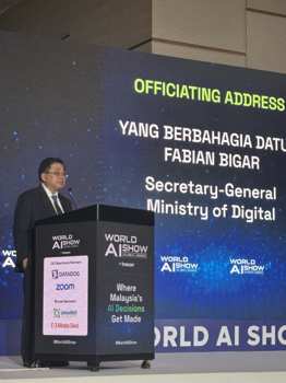 Datuk Fabian Bigar, Secretary-General of Malaysia's Ministry of Digital, speaking at the podium during his officiating address at World AI Show Kuala Lumpur